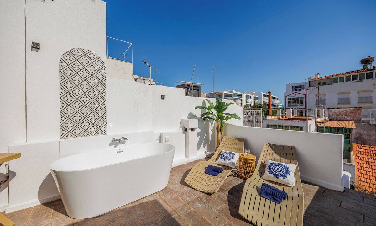 Portimao City Centre House | Just steps from Portimão's promenade, marina and beaches, this stylish home offers AC, sun deck with jacuzzi, a fully equipped kitchen and comfortable living spaces. Perfect for families, friends or business stays exploring the Algarve.